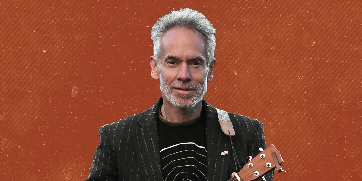 Promotional image of Dominic Frisby - An Evening of Comedy, Songs and Satire